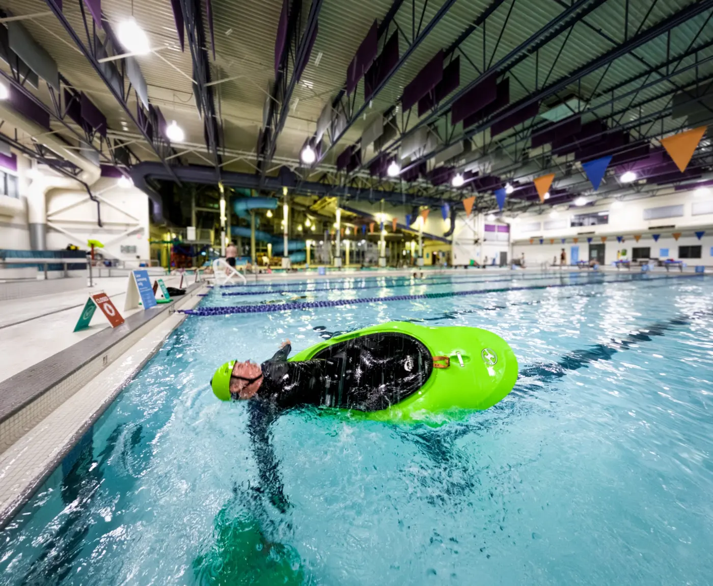 A kayaker practising a roll during an Airdrie Kayak Club pool session